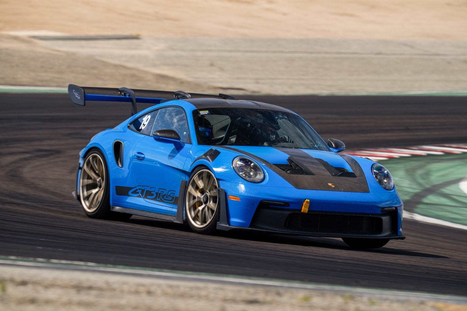 Blue Porsche GT3 RS cornering on track